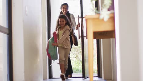 Mixed-race-mother-and-daughter-enter-the-house