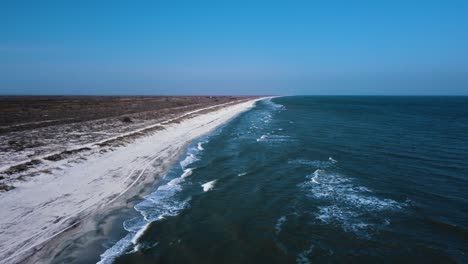 The-seashore-from-above-with-waves-crashing-on-the-beach