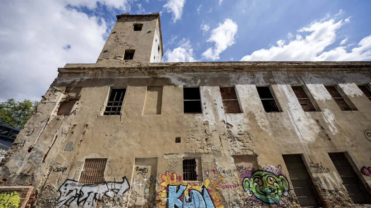 Old factory and industrial complex with passing clouds