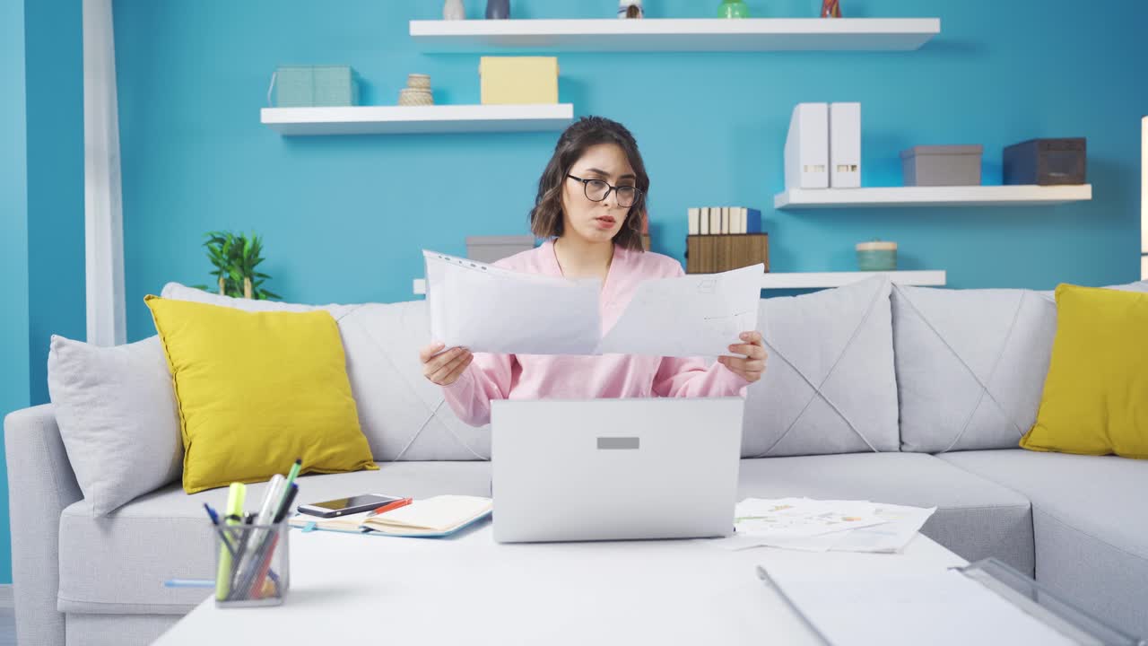 Angry young woman working in her home office.