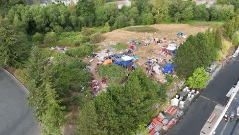 aerial shot of a homeless community with junk strewn everywhere