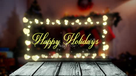 Animation-of-happy-holidays-text-on-fairy-lights-banner-over-wooden-plank-against-decorated-house