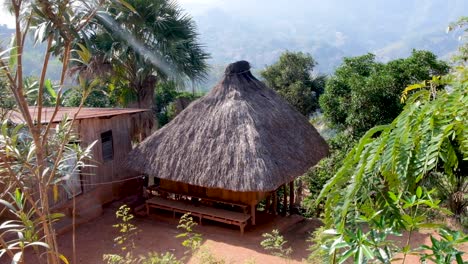 A-beautiful-thatched-roof-traditional-Timorese-house-in-a-remote-village,-in-the-mountains,-surrounded-by-trees,-near-the-capital-Dili,-Timor-Leste,-Southeast-Asia