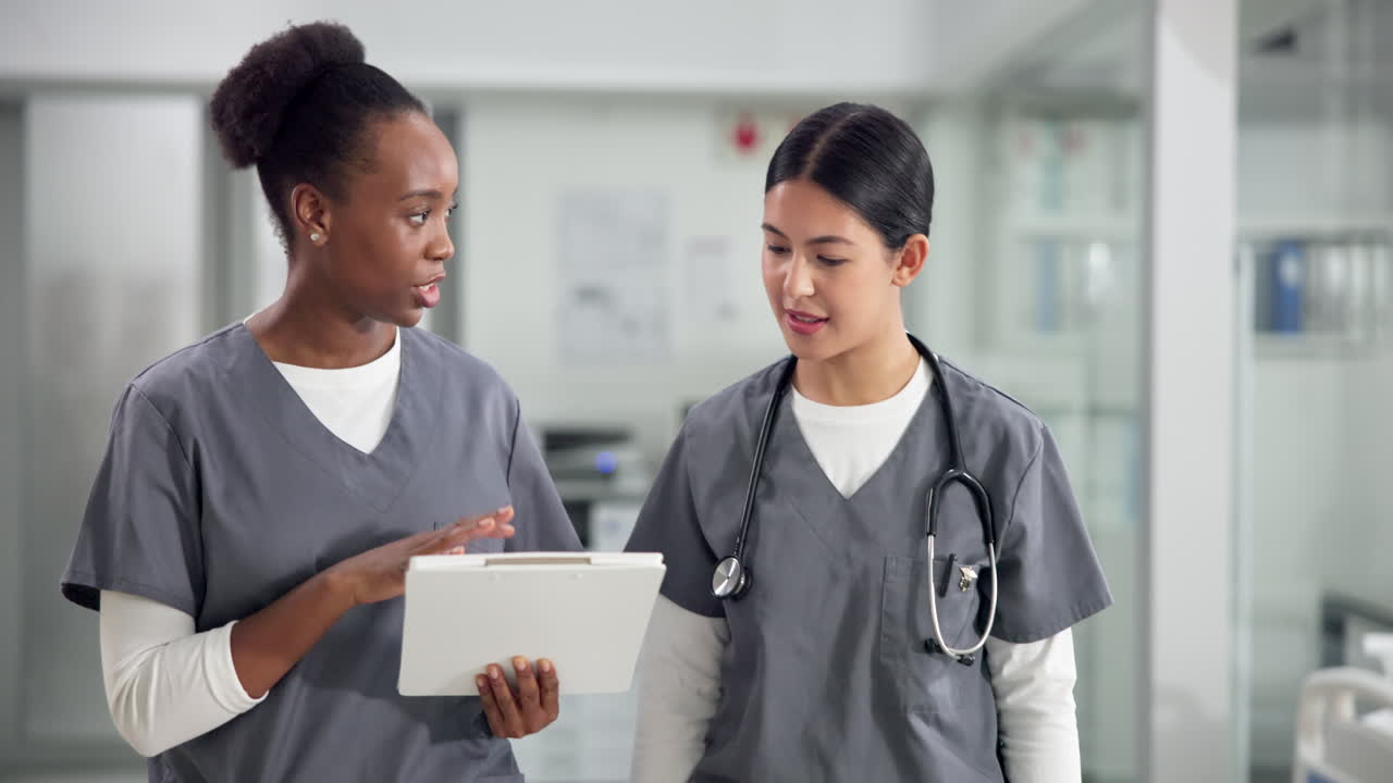 Two Nurses Discussing Patient Care in a Hospital