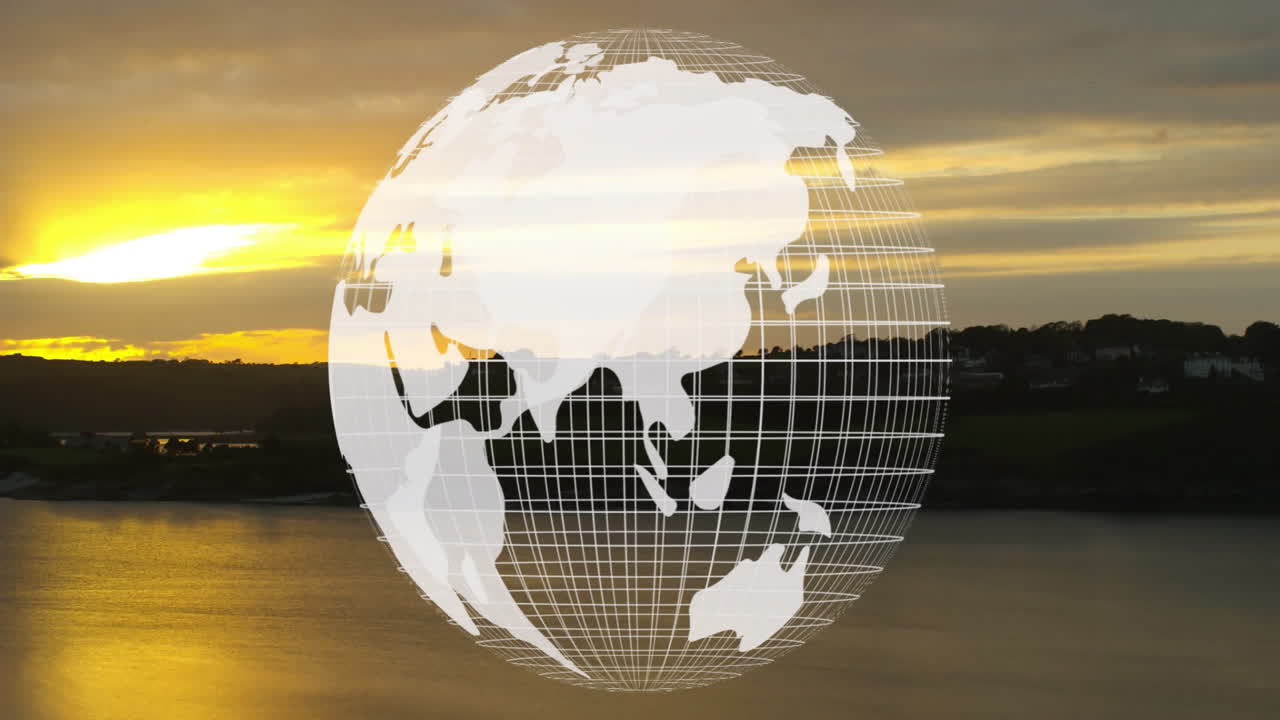 Rotating globe animation over sunset landscape with water and distant hills