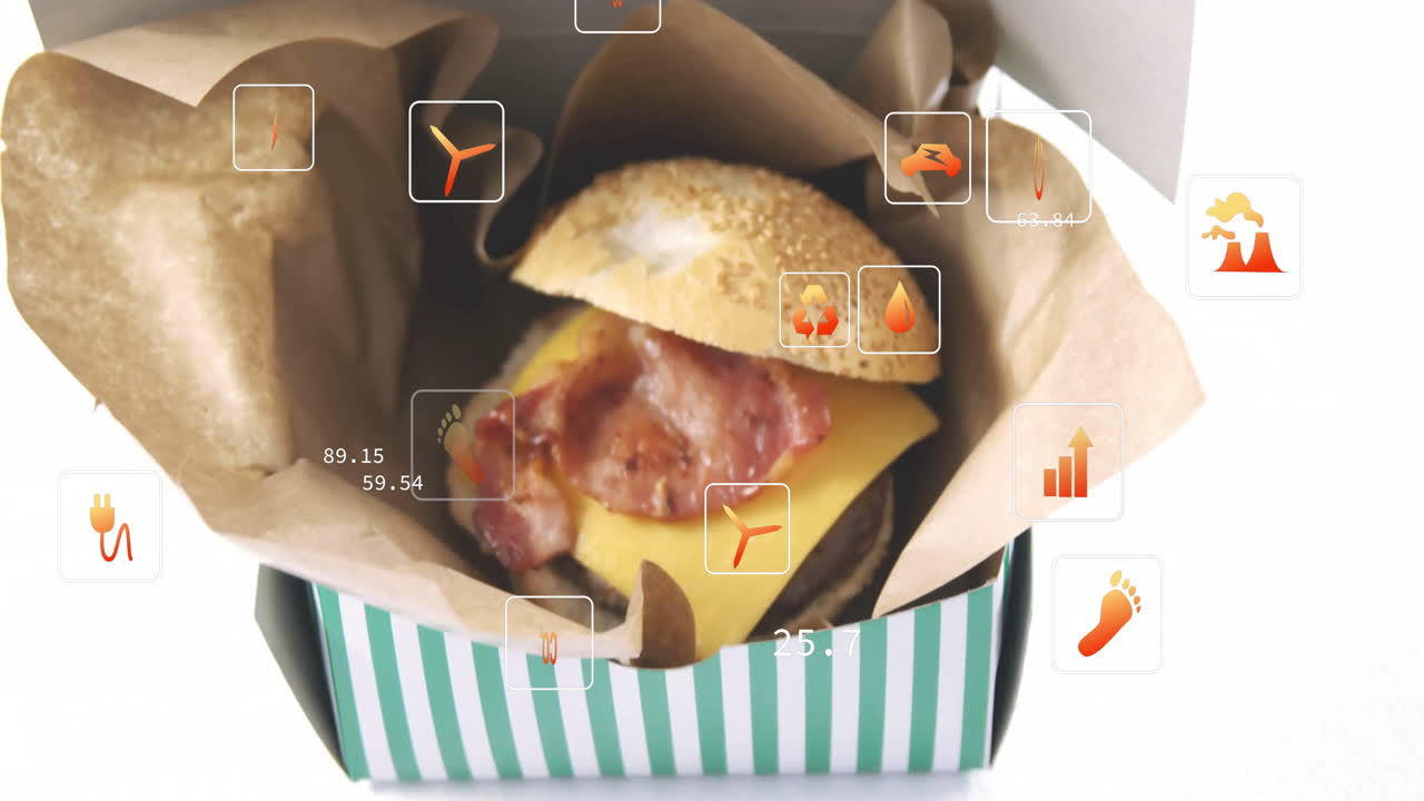 In school, animation of burger with cheese and bacon, digital data icons overlaying