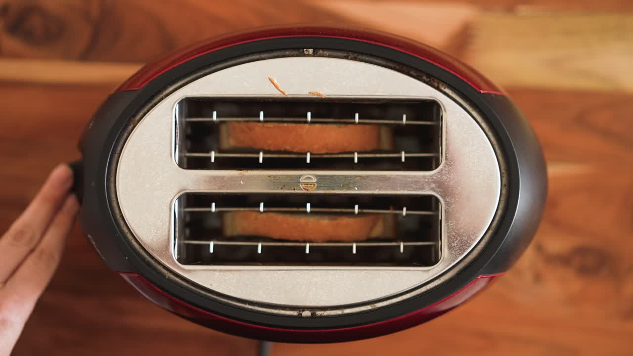Premium stock video - Sliding sliced white bread inside a toaster on ...