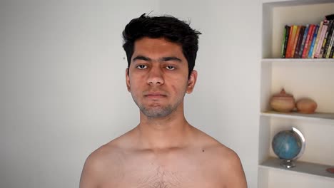 portrait of young man taking off his t-shirt