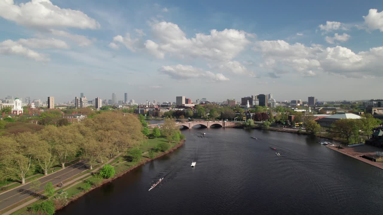 Charles River, Boston with rowing teams from Harvard University, 4K aerial