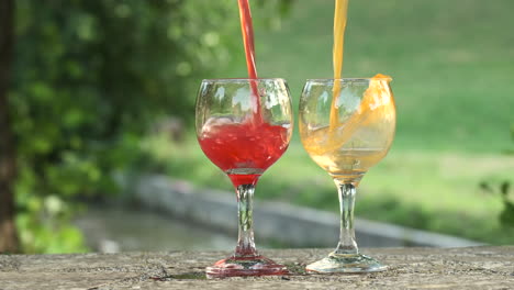 slow motion of pouring orange juice into glass