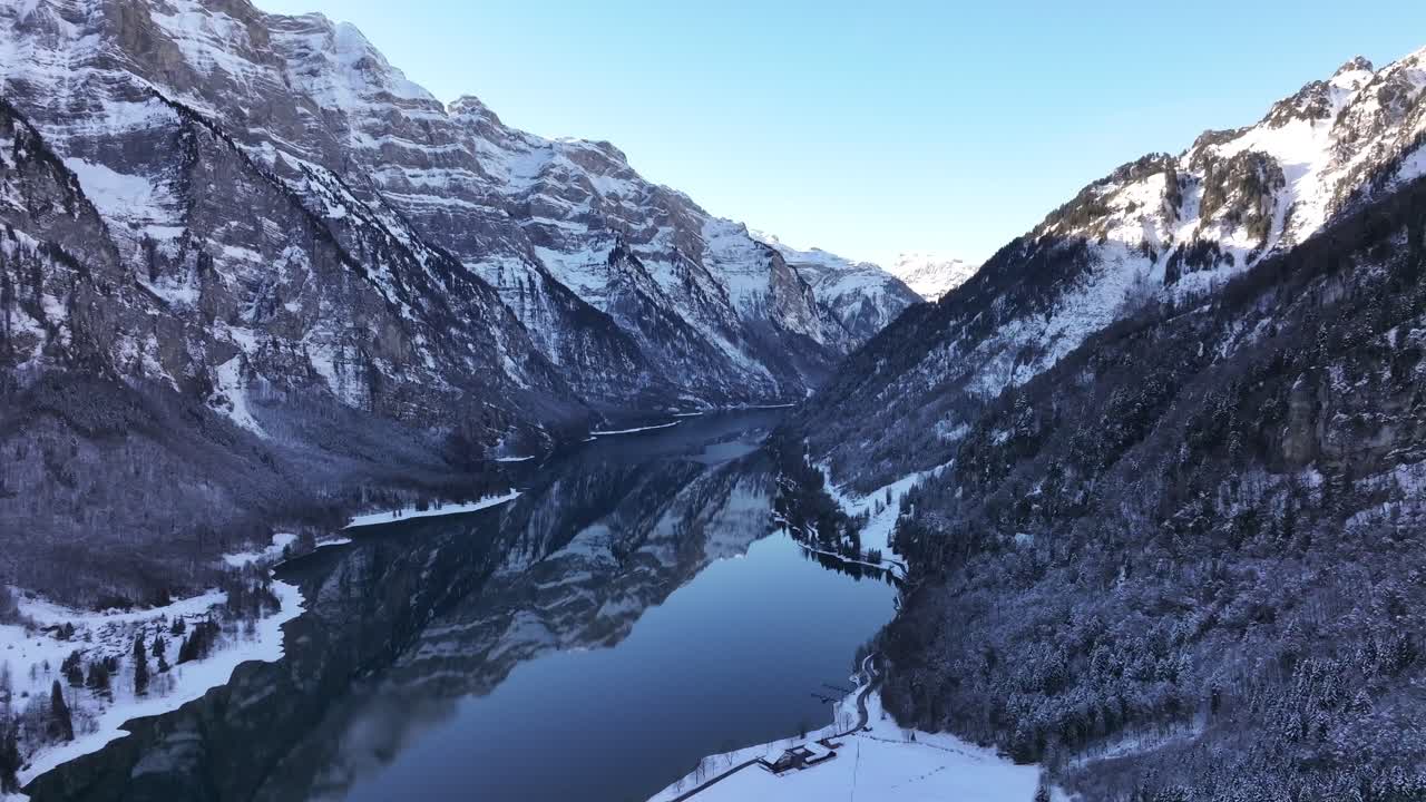 Bird's-eye view of the Swiss Alps and the magnificent Lake Klöntalersee on a typical winter day in Switzerland.
