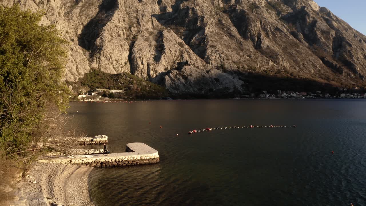 AERIAL - Bay of Kotor in the ancient city of Kotor, Montenegro, reverse shot