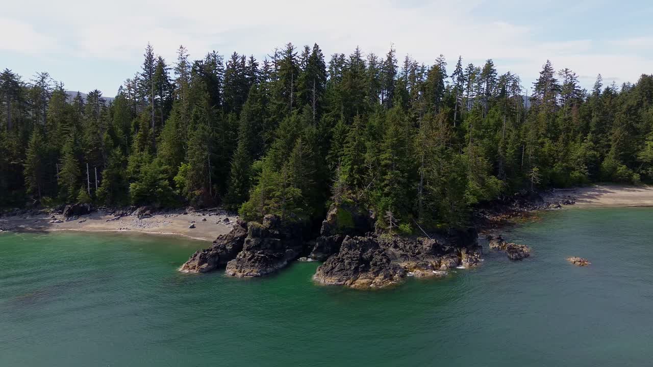 Aerial Orbital View of Moresby Island's Coastal Forest, Rocky Outcrops, and Beach Coves in BC, Canada