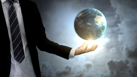 businessman holding digital generated globe