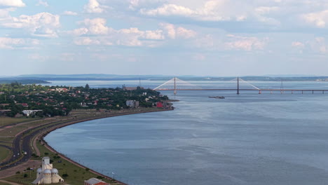 drone view of san roque gonzález de santa cruz international bridge in encarnación, paraguay, connection with posadas argentina, aerial