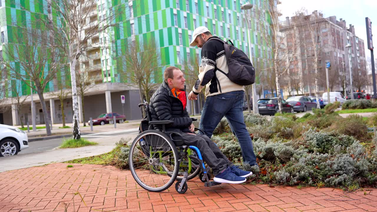 Man in Wheelchair Receiving Assistance Outdoors