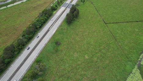 traffic on pacific motorway through green rural landscapes in tanglewood, nsw, australia