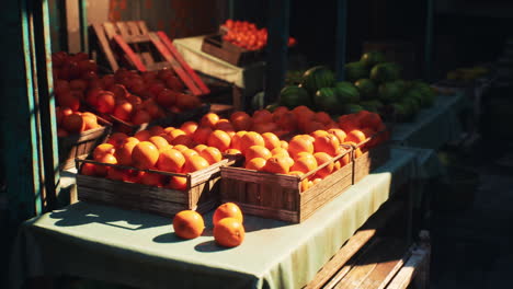 oranges and watermelons in wooden crates at a market stall