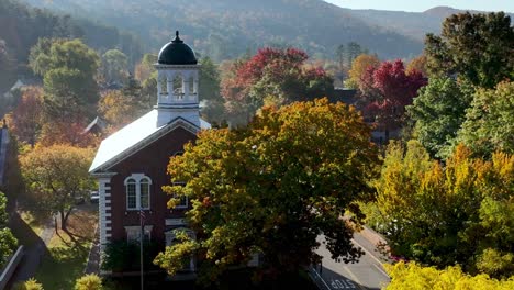 new england, woodstock vermont in fall aerial of courthouse in autumn with autumn leaves at treetop level