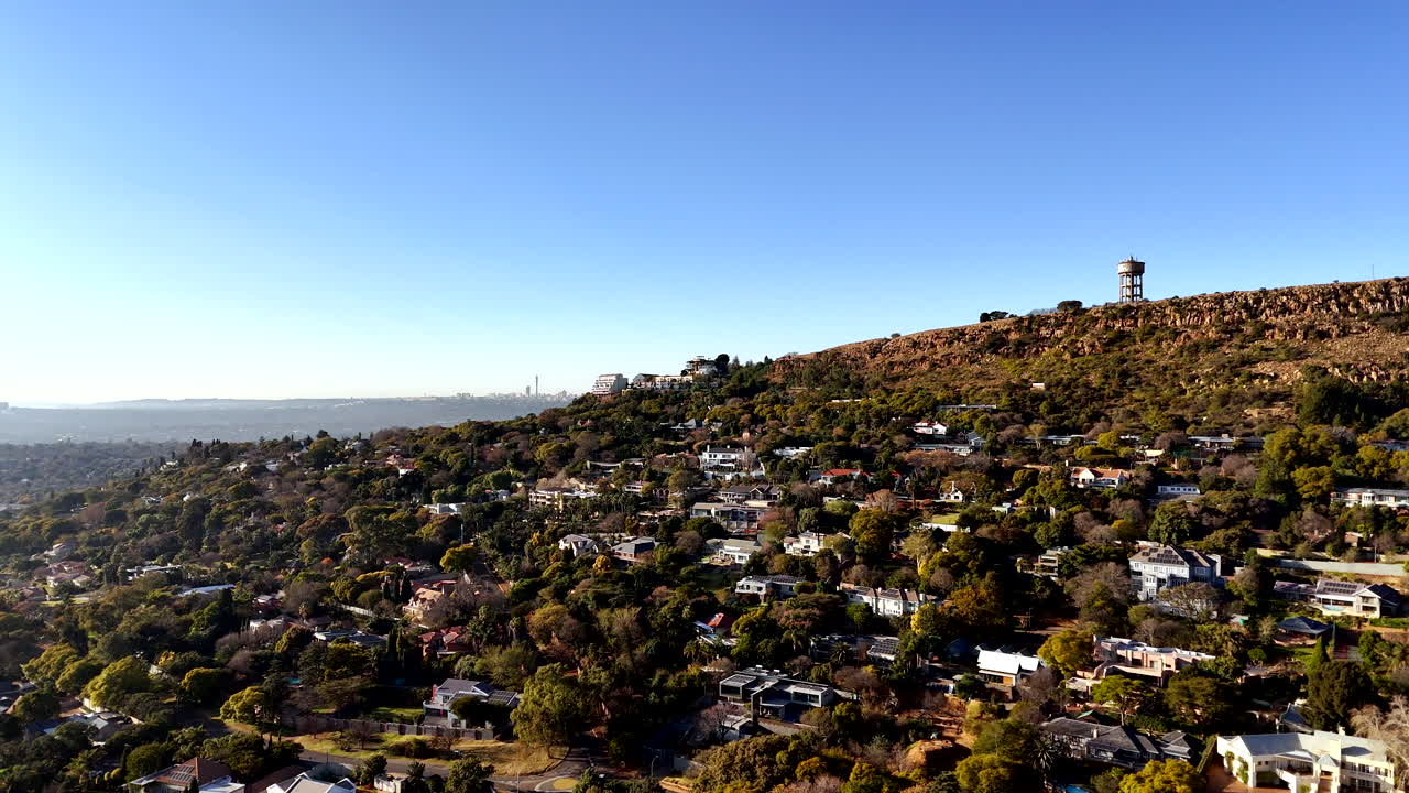 Drone pan over Northcliff residential suburb in Johannesburg with water tower