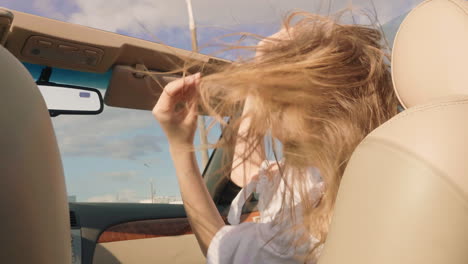 woman enjoying a summer road trip in a convertible