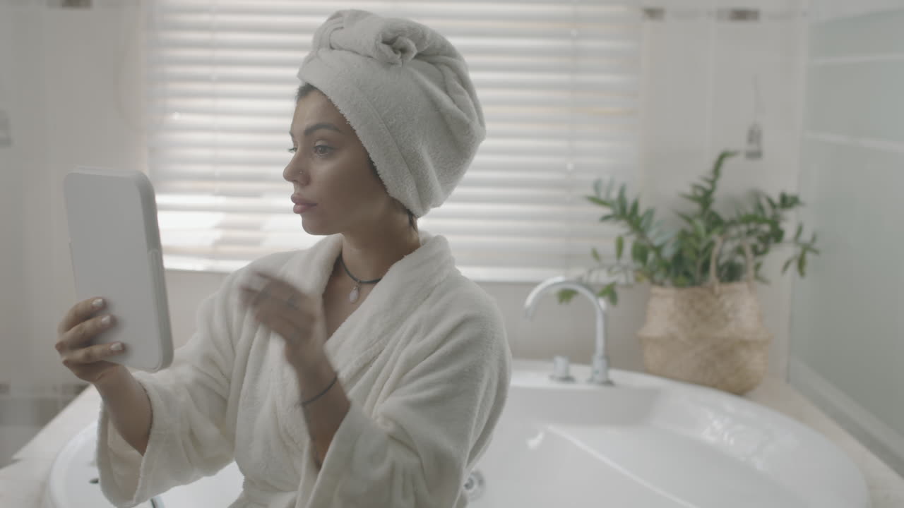 Young Girl Applying Face Oil after Taking Bath
