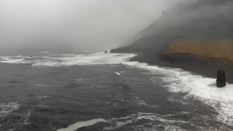 Aerial-footage-over-a-black-beach-in-Djupavogshreppur,-Iceland-8