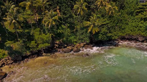 stunning aerial footage showcasing the beauty of mirissa beach, sri lanka. this breathtaking 4k drone shot captures the golden sands, turquoise waters, and lush palm trees lining the coast.