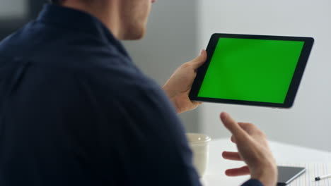 close-up view of business man making video call on tablet with chroma key