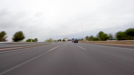 driving-a-car-on-the-barcelona-motorway-highway-in-spain,-fast-camera-mounted-on-the-front-time-lapse-with-motion-blur