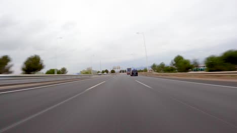 driving a car on the barcelona motorway highway in spain, fast camera mounted on the front time lapse with motion blur