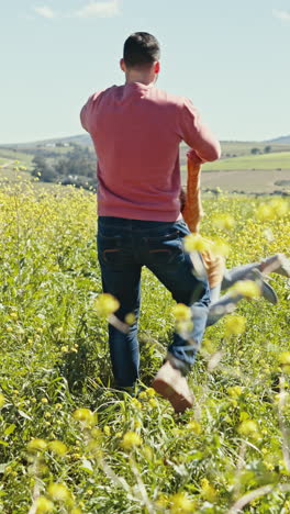 Father,-child-and-happy-spinning-in-grass-field