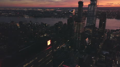 AERIAL:-Manhattan-Drone-Flight-at-Night-with-Glowing-City-Light-in-New-York-City