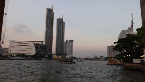 time-lapse of sunset behind city skyline over river