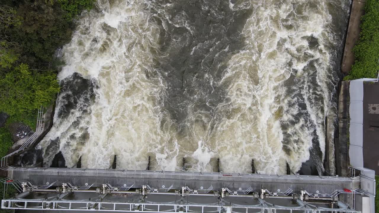 Overhead drone footage of weir on river Thames at marsh lock near Henley UK 