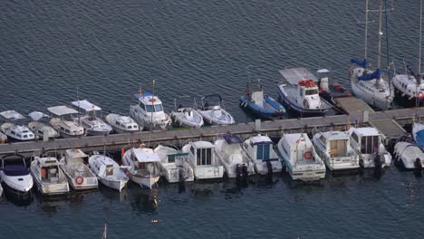 Blanes-city-on-the-Costa-Brava-of-Spain,-tourist-beach-town-sunset-and-night-images-marina-and-fishing-port-moored-boats-small-boats