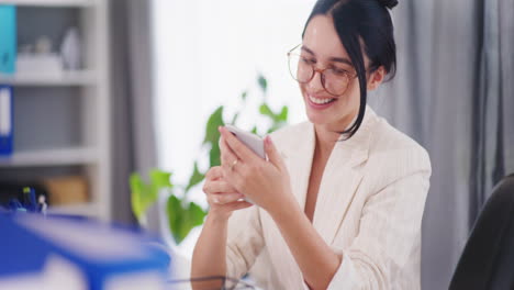 Happy-Woman-Takes-Selfie-with-Smartphone-in-Office