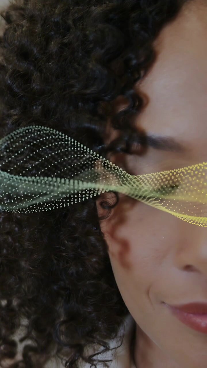 Vertical video: Woman holding calm pose app playing dot waveform shifting across face as tech demo