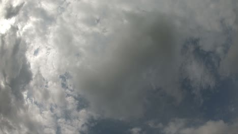 time lapse of cloudscape with bright sun shining and revealing itself behind clouds.