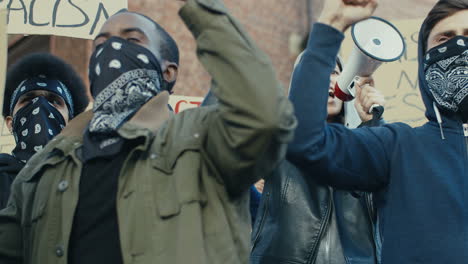 group of multiethnic people yelling in a protest against the racism in the street