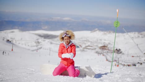 snowboarder putting on her gloves