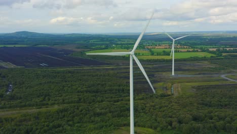 aerial view of wind turbines energy production- 4k aerial shot on sunset