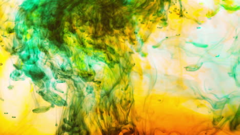 green and orange paint or dye dropped into water against white background to create swirling colourful smoke background 7