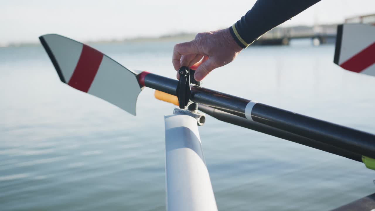 Senior caucasian man preparing rowing boat in a river