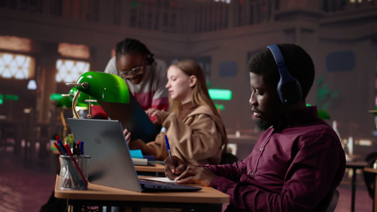 Vertical video young adult listening to study music and writing ideas for bachelor paper