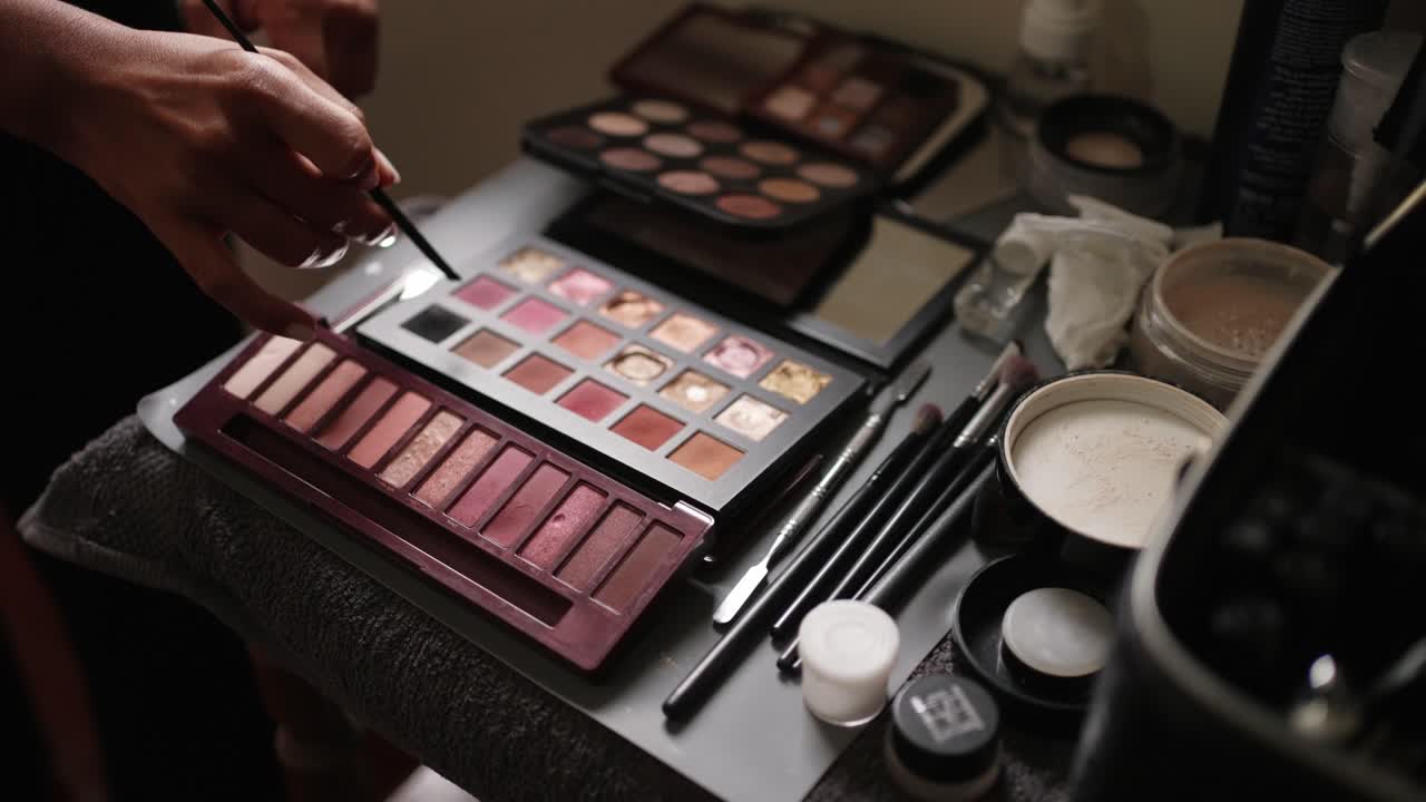 Close up of makeup tools and palettes arranged for wedding styling