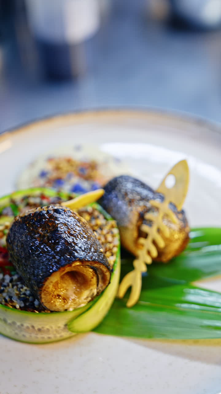 Beautiful serving of fish and vegetables on the rotated plate. Savory mouth-watering dish with lovely décor. Close up. Vertical video.