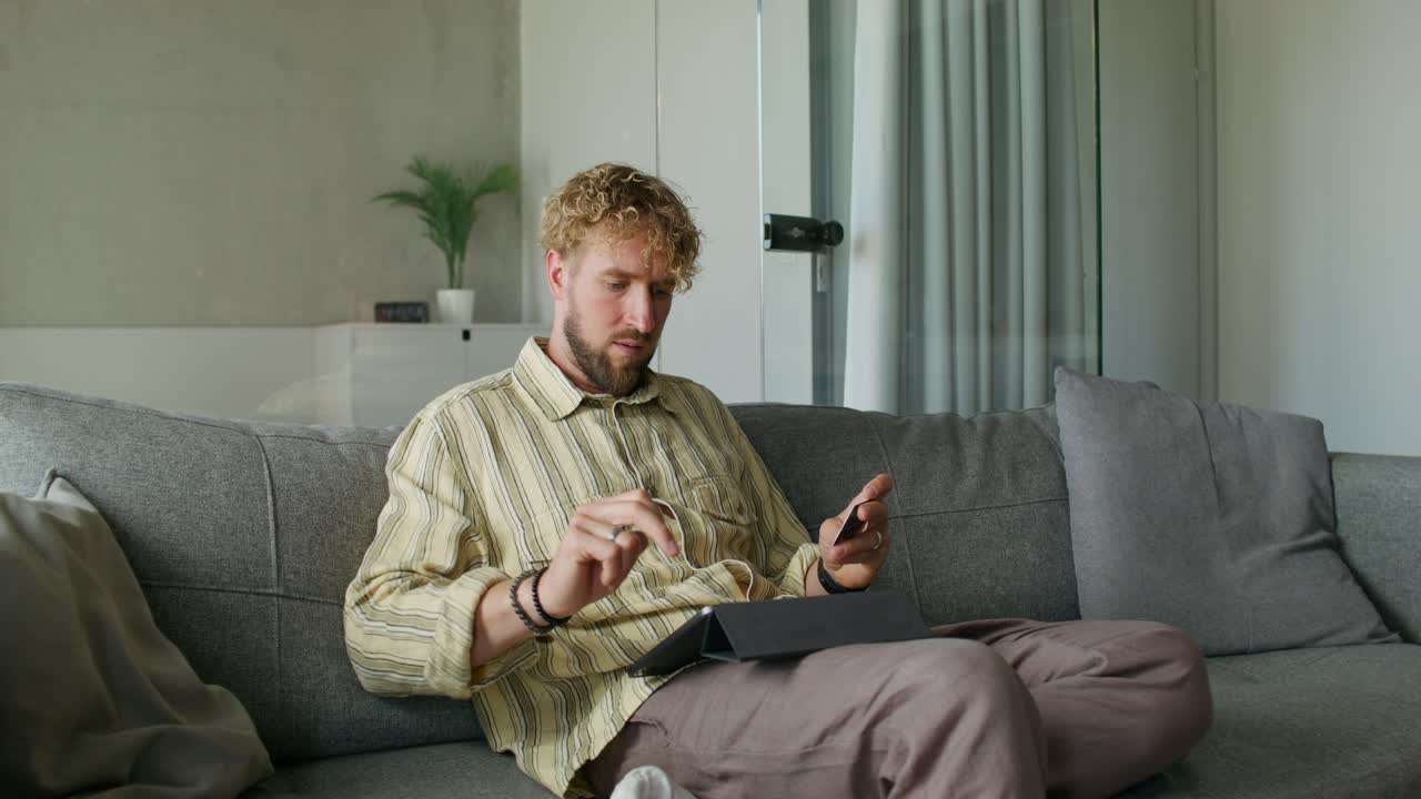 Man using a tablet on a couch