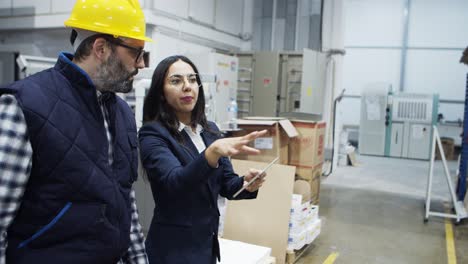 side view of young boss giving instructions to mature engineer