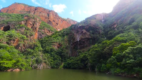 Montaña-Con-Bosque-Verde-Y-Cascada-Sobre-El-Agua,-Sudáfrica